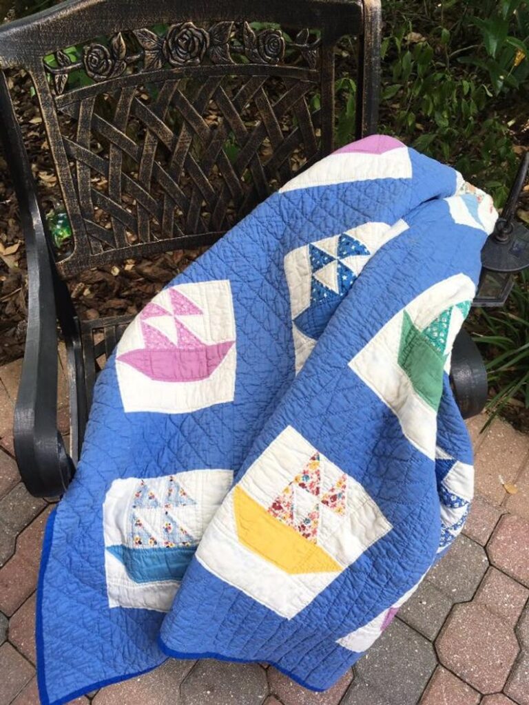  a sailboat quilt placed on the armchair