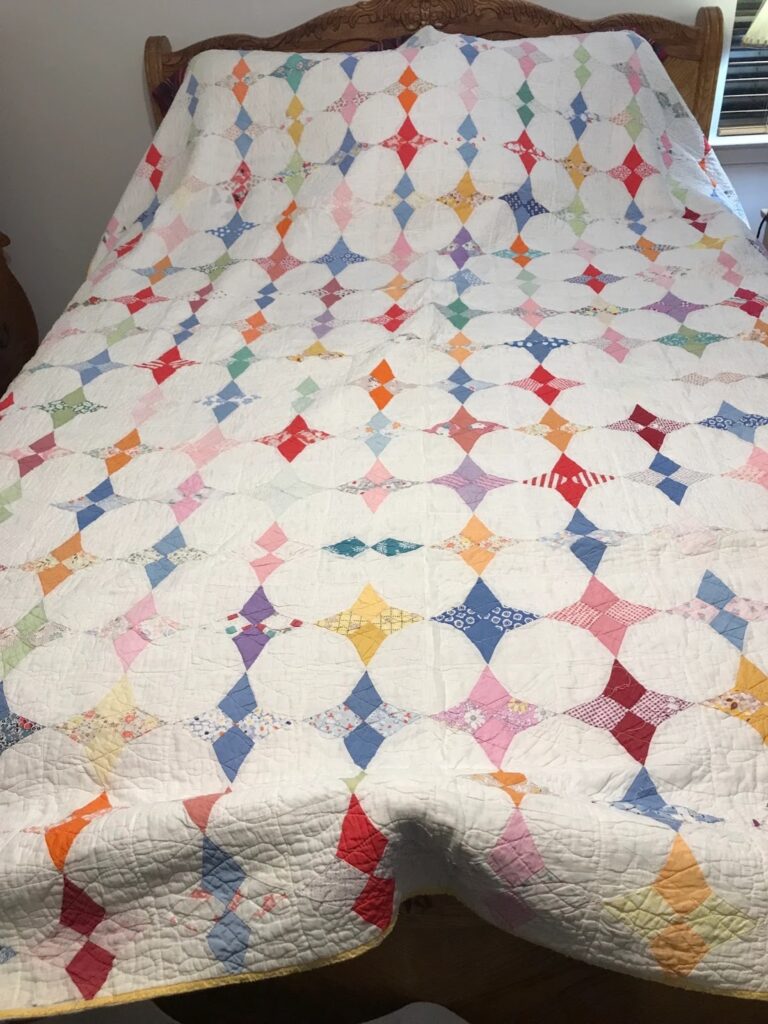 a quilt with a star pattern is spread on the bed