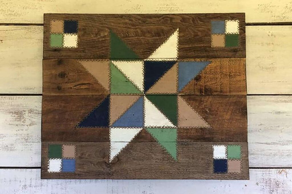 a star pattern barn quilt hanging on the wooden wall.