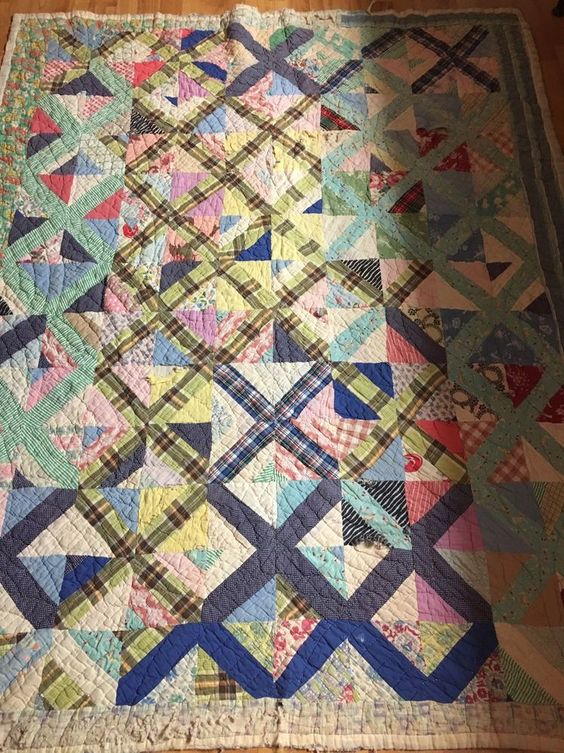 a hand-stitched quilt on a wooden floor