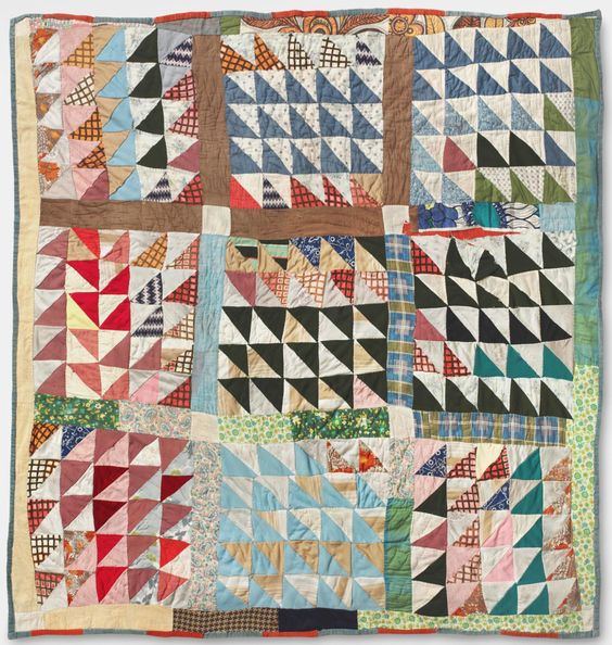 a quilt with triangles in squares patterns