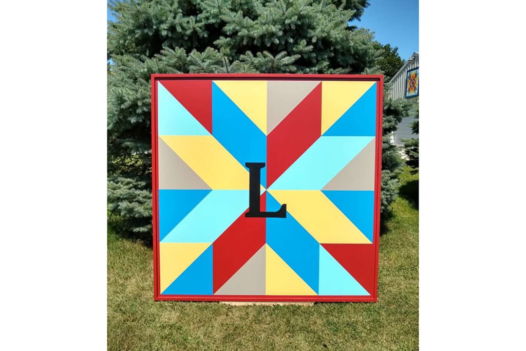 a monogram barn quilt set in the garden