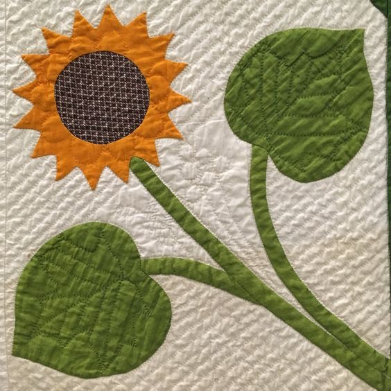 a quilt with a sunflower pattern