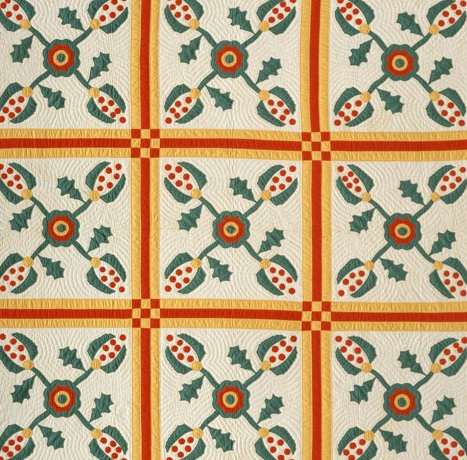 a quilt with a pattern of pomegranates