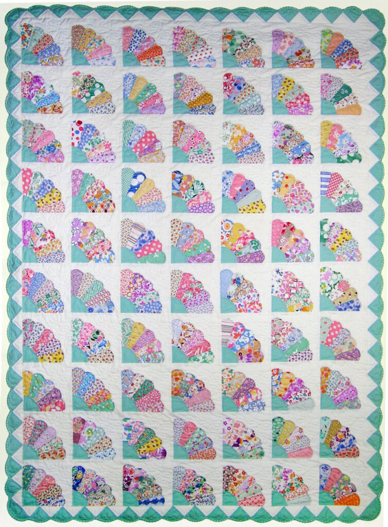 a quilt with a pattern of paper fans