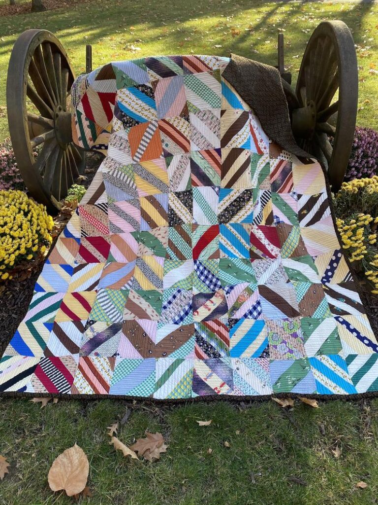 a quilt with diagonal patterns placed next to the wheel