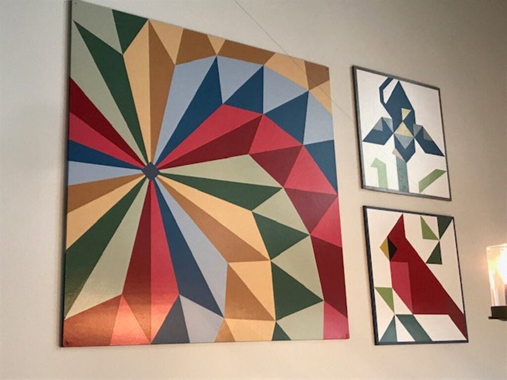 three barn quilt hanging on the wall