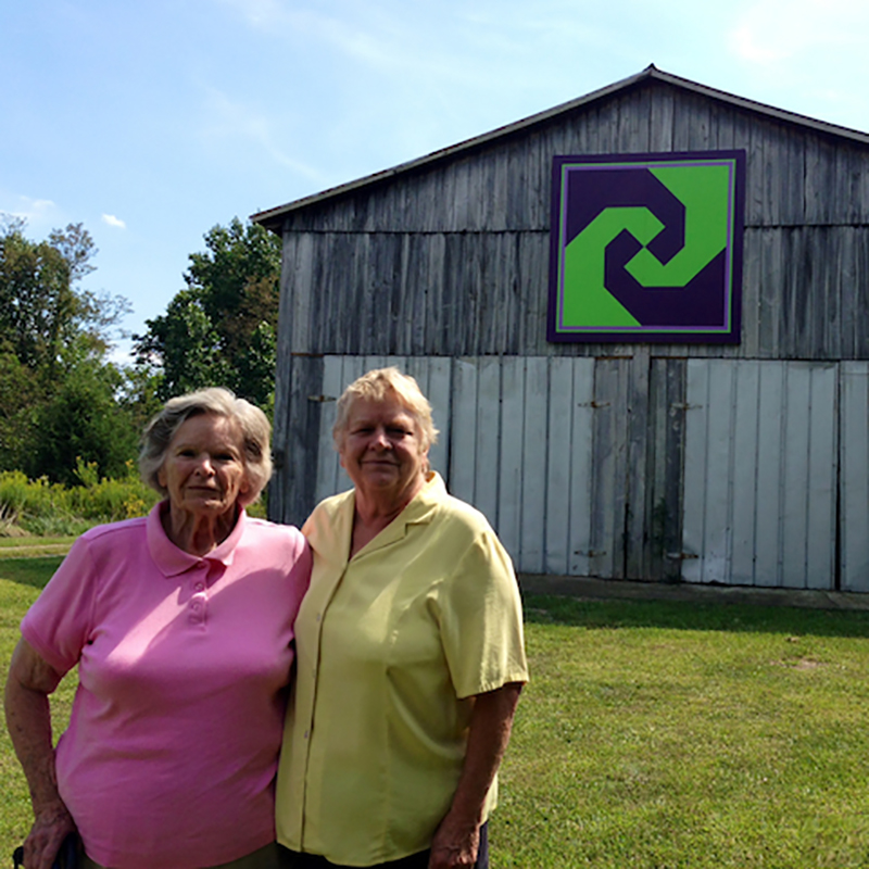 Donna Sue Groves and her mother in font of a barn
