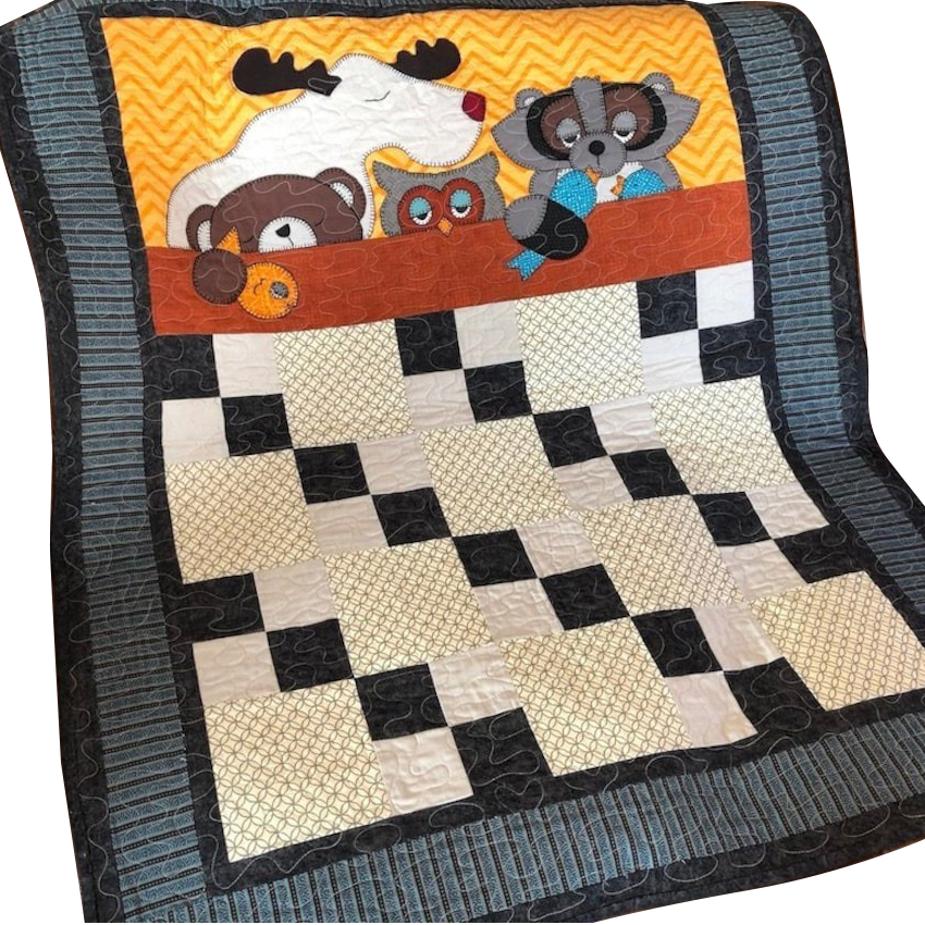 A cute baby boy quilt with forest animals for the bed