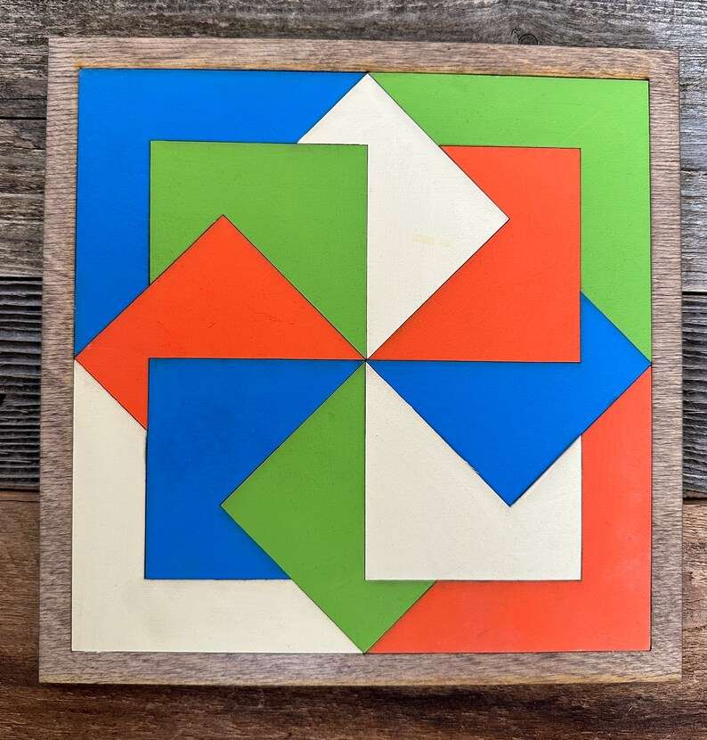 a small barn quilt laying on the wooden floor