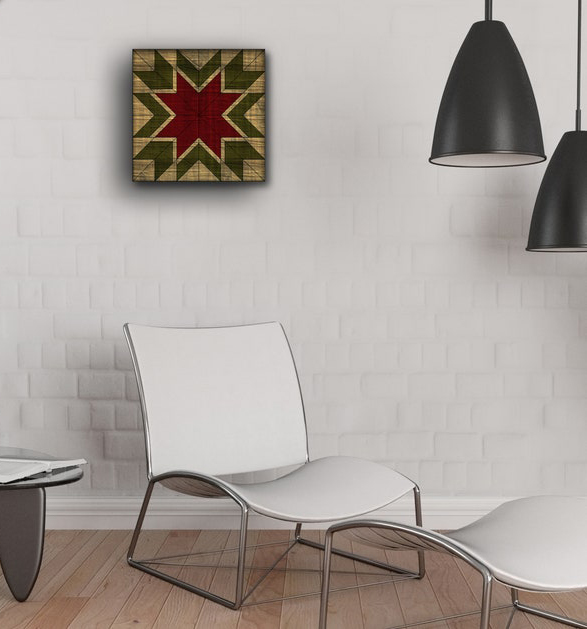 a small barn quilt hanging on the wall, in the room space, there are two black lights, a white chair, and a table.