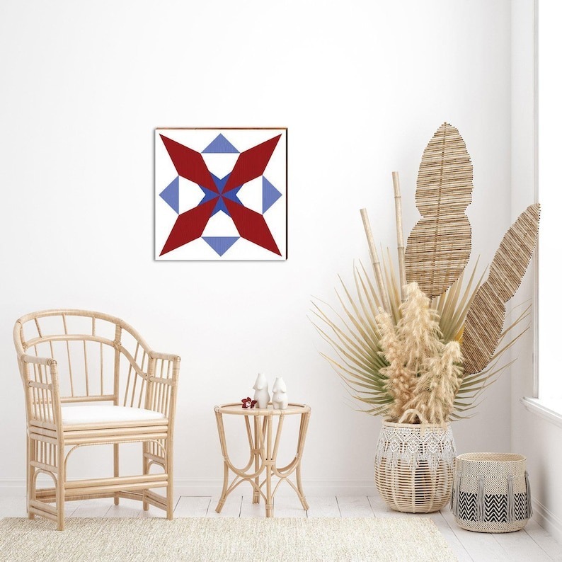 a barn quilt with compass pattern hanging on the wall