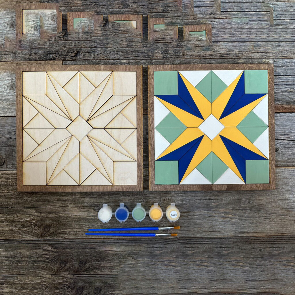 two barn quilt with 4 tulips partern in yelow and blue placed on the wooden surface.