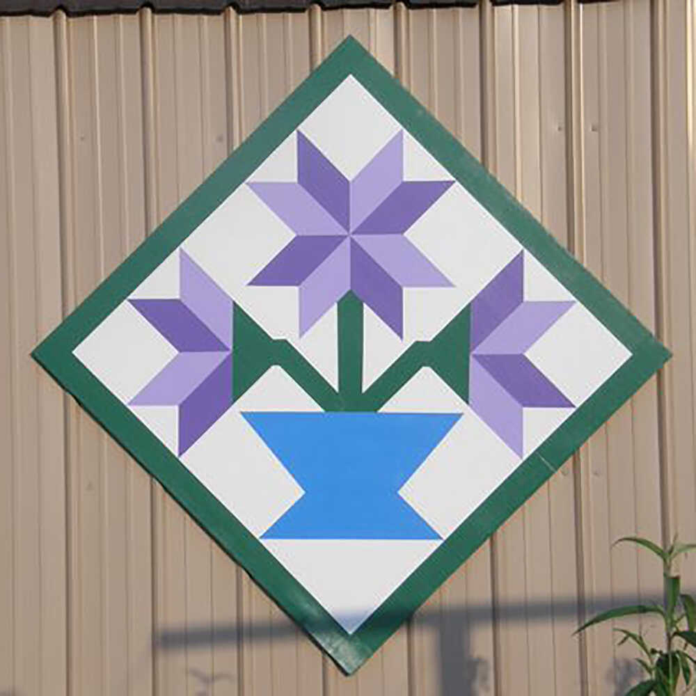 a barn quilt with flower pot pattern