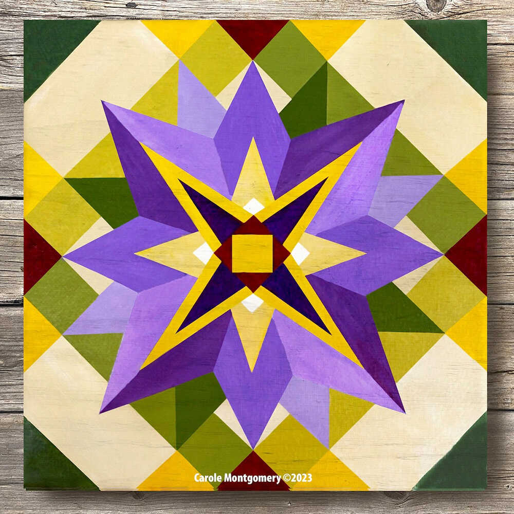a barn quilt with purple flower pattern laying on the wooden floor