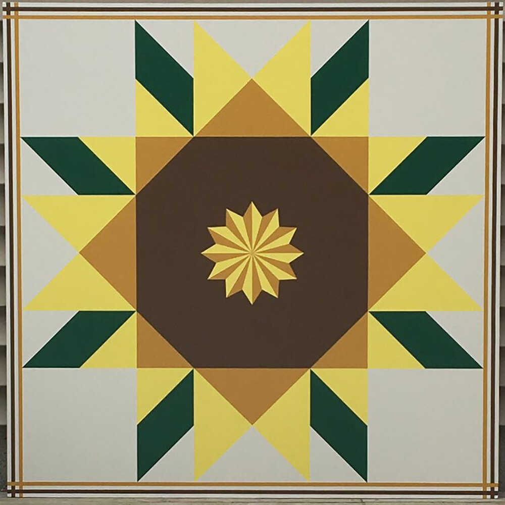 a barn quilt with sunflower pattern