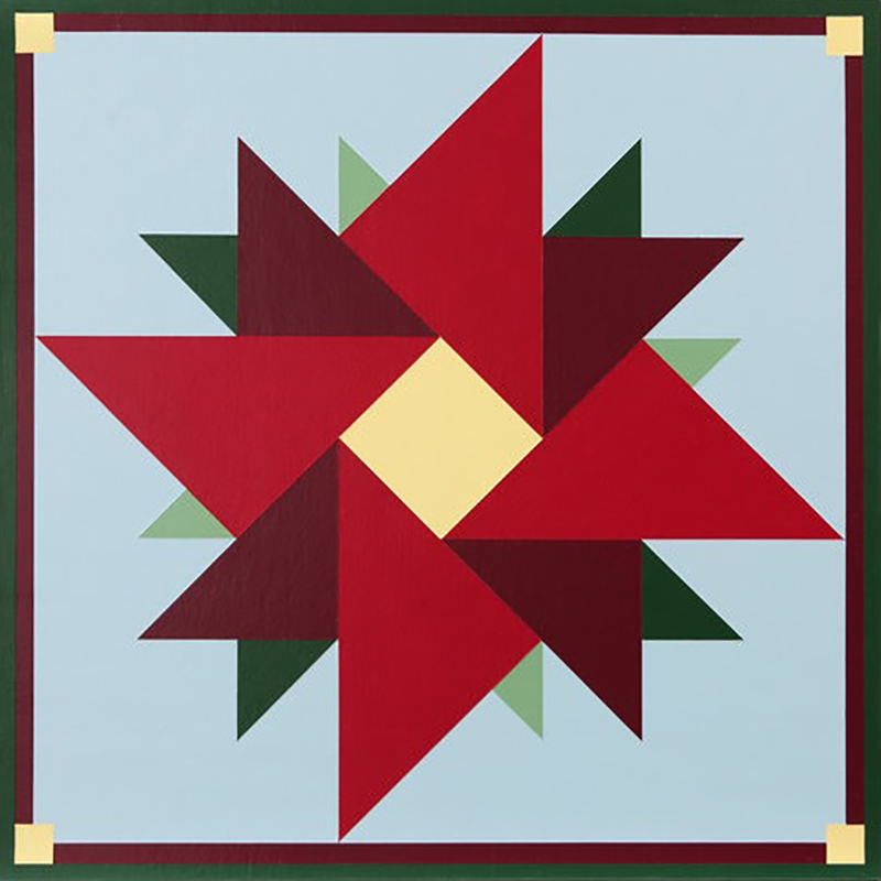 a barn quilt with red rose flower pattern