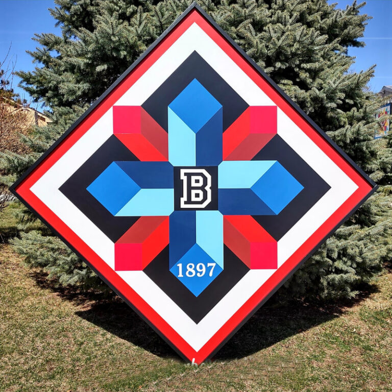 Barn quilt with blue and red cylindrical shapes and initials
