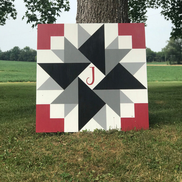 Black and gray pinwheel barn quilt with initials