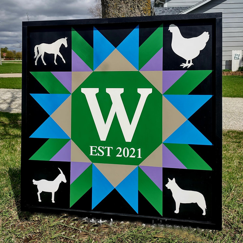 a barn quilt-with-four animals and blue star