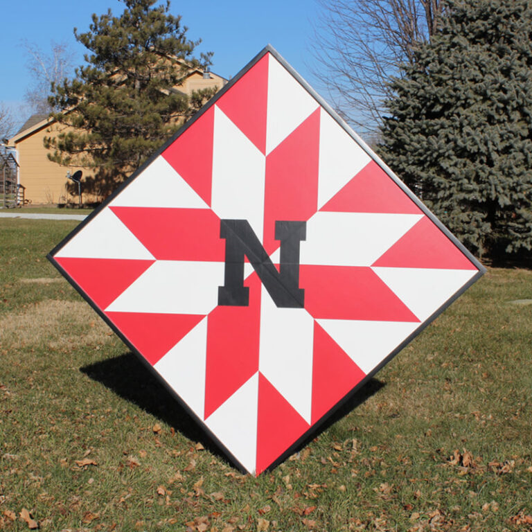 Red and white geometric barn quilt with initials