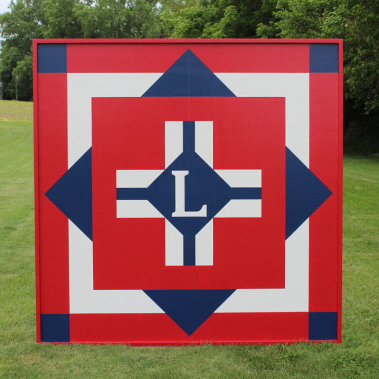 White and blue plus sign barn quilt – Red background
