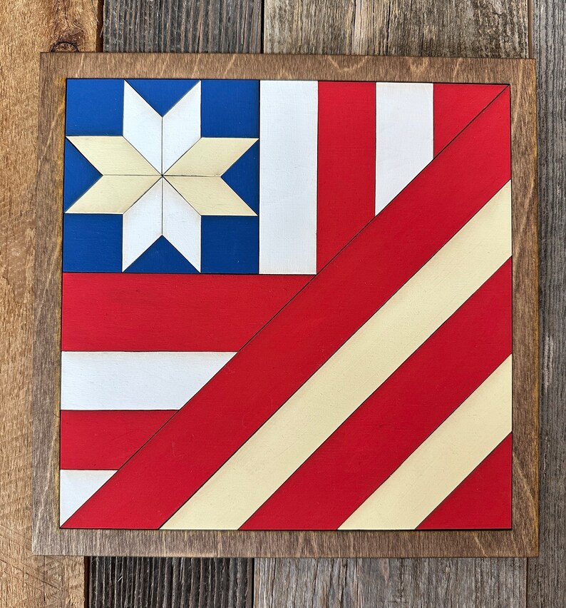 a barn quilt with american flag pattern placed on the wooden wall