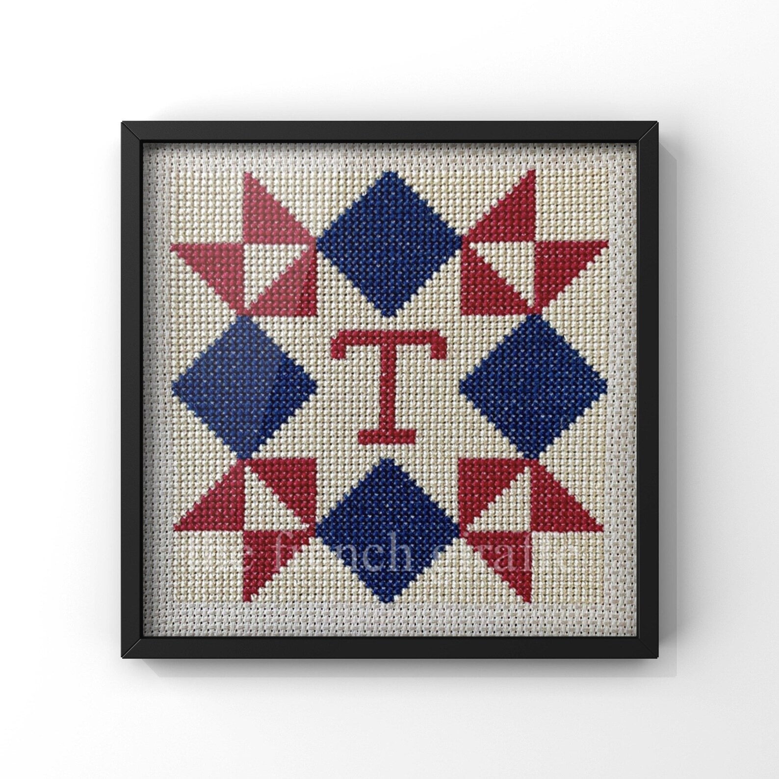 a barn quilt with American Flag and a "T" letter pattern.
