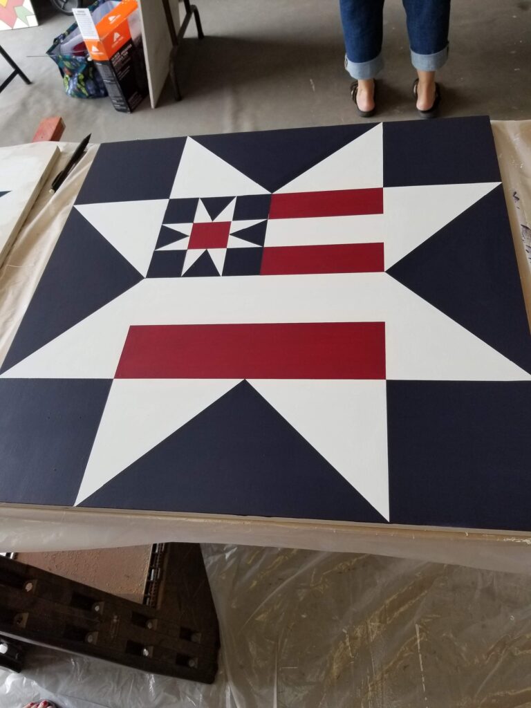 a barn quilt American Flag pattern placed on the table