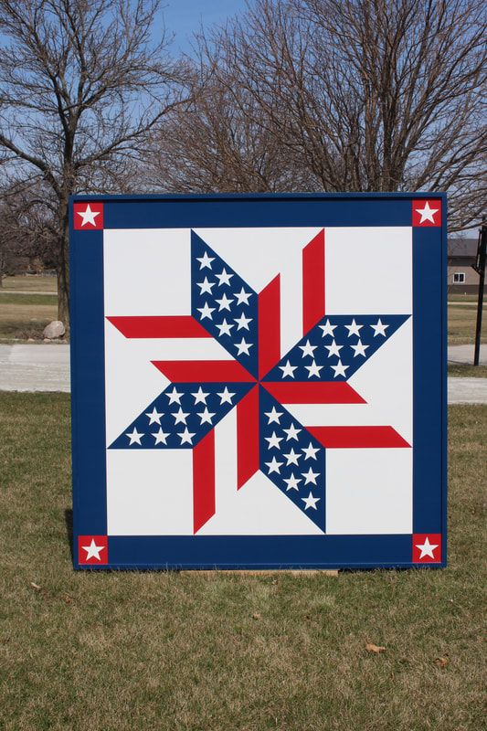 a barn quilt placed on the garden