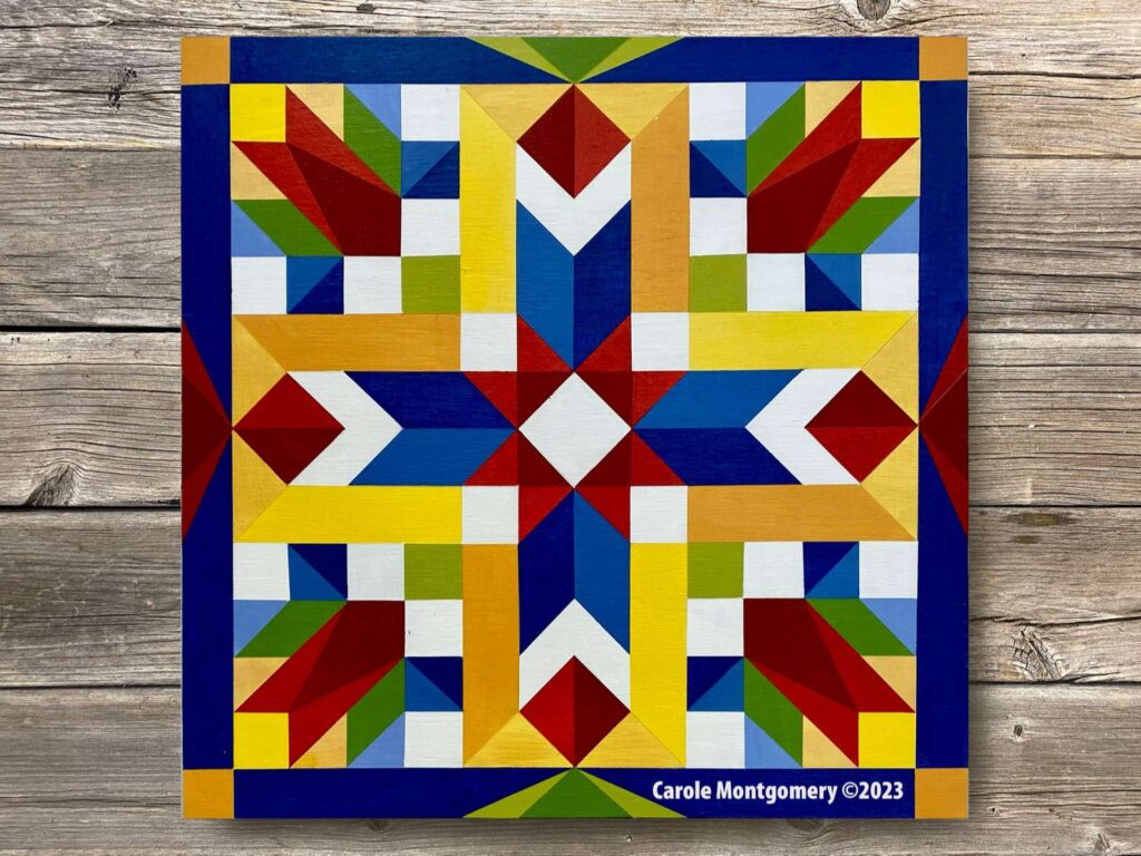 a spring rising barn quilt laying on the wooden floor