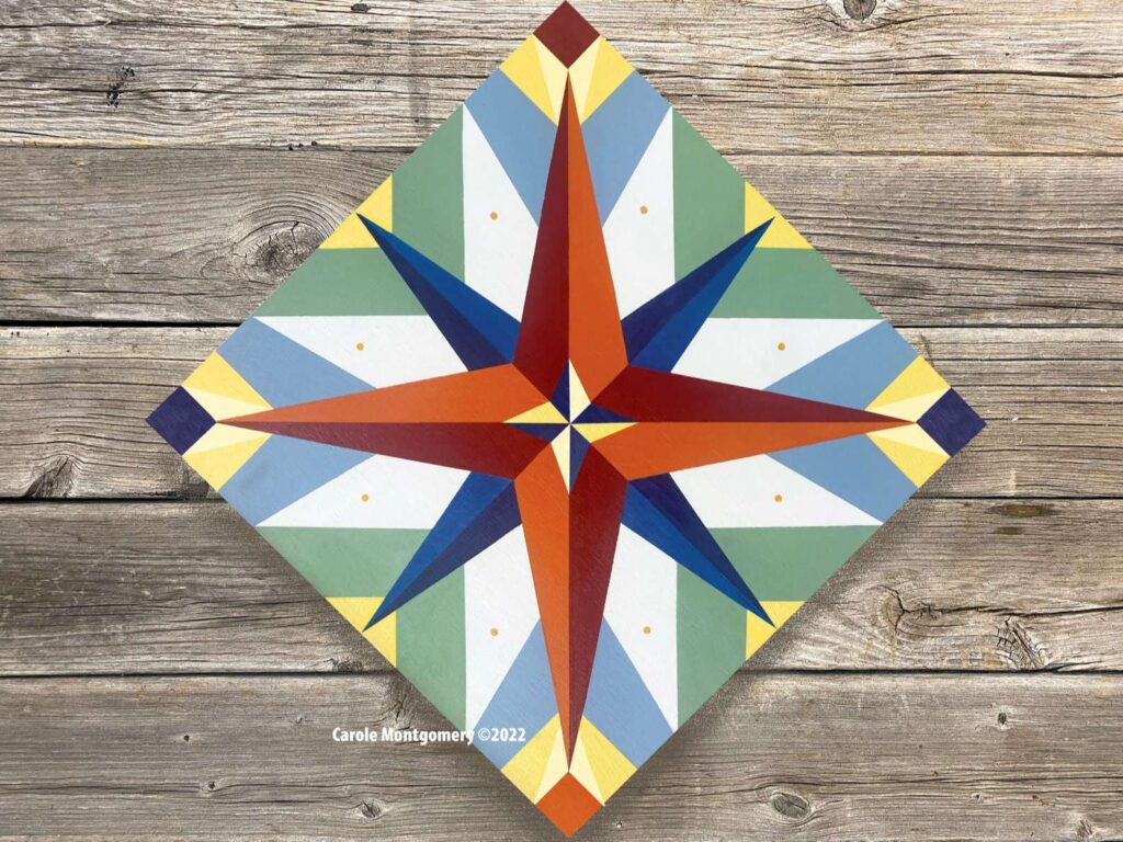a mariner's compass barn quilt laying on the wooden wall