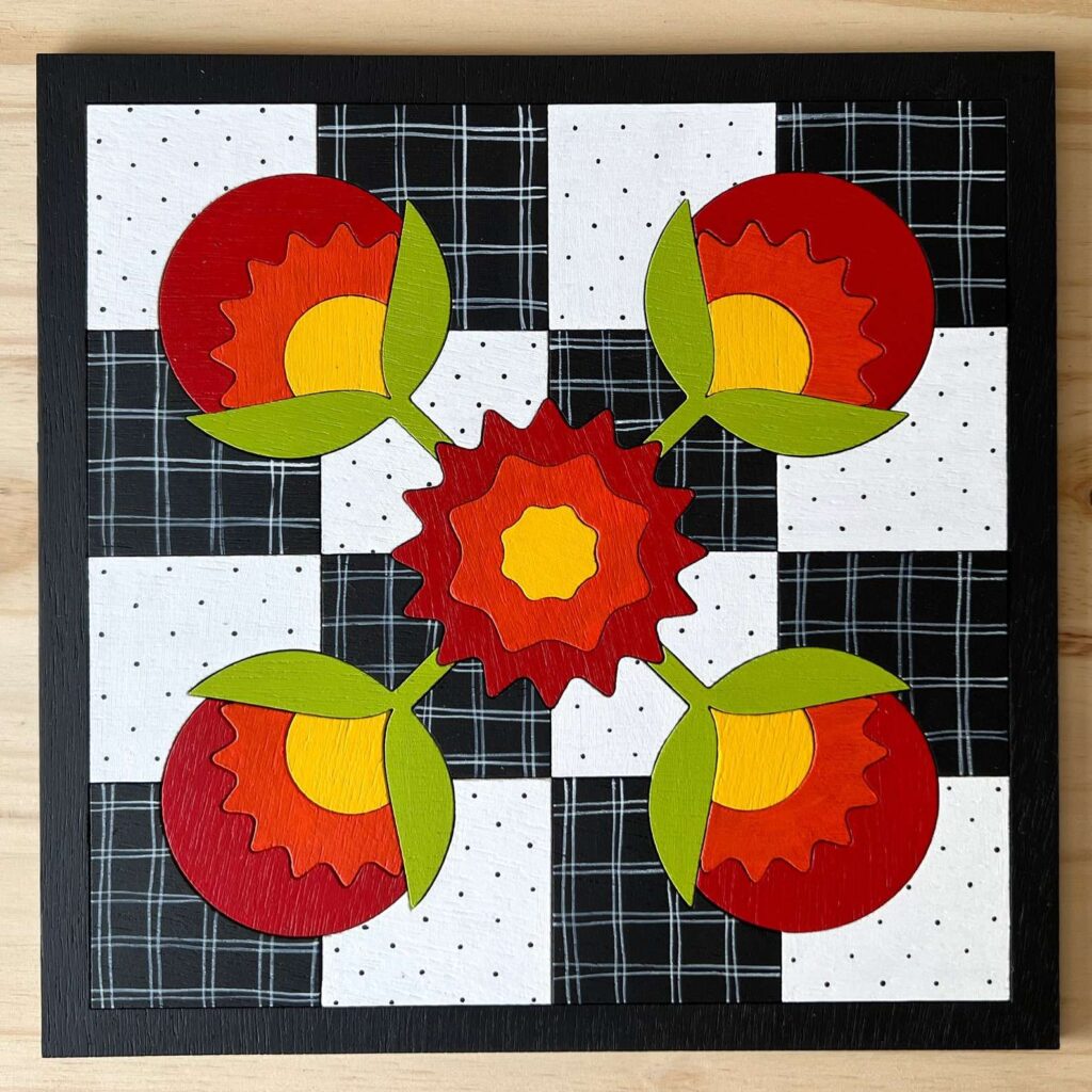 a night lamp barn quilt laying on the wooden floor