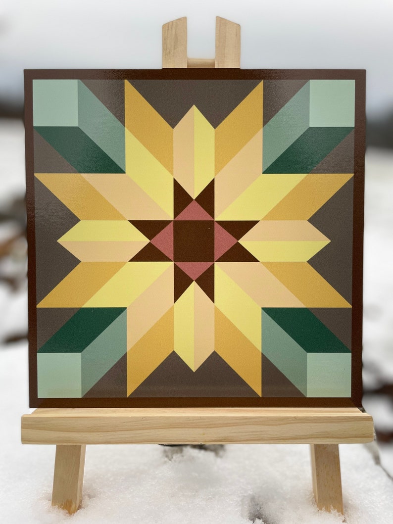 a barn quilt placed on the wooden rack