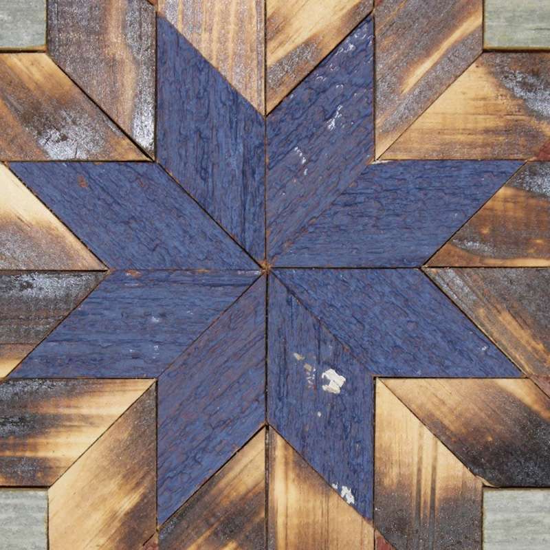 the center of this barn quilt with blue star pattern
