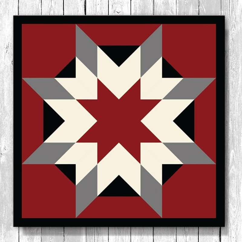 a barn quilt with the gray and white stars pattern