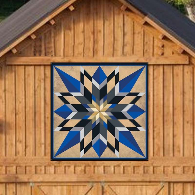 a barn quilt with blue star pattern hanging on the wooden barn