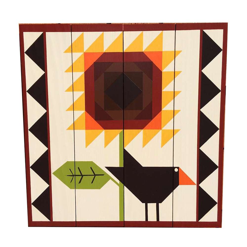 a barn quilt with the black crow and sunflower pattern