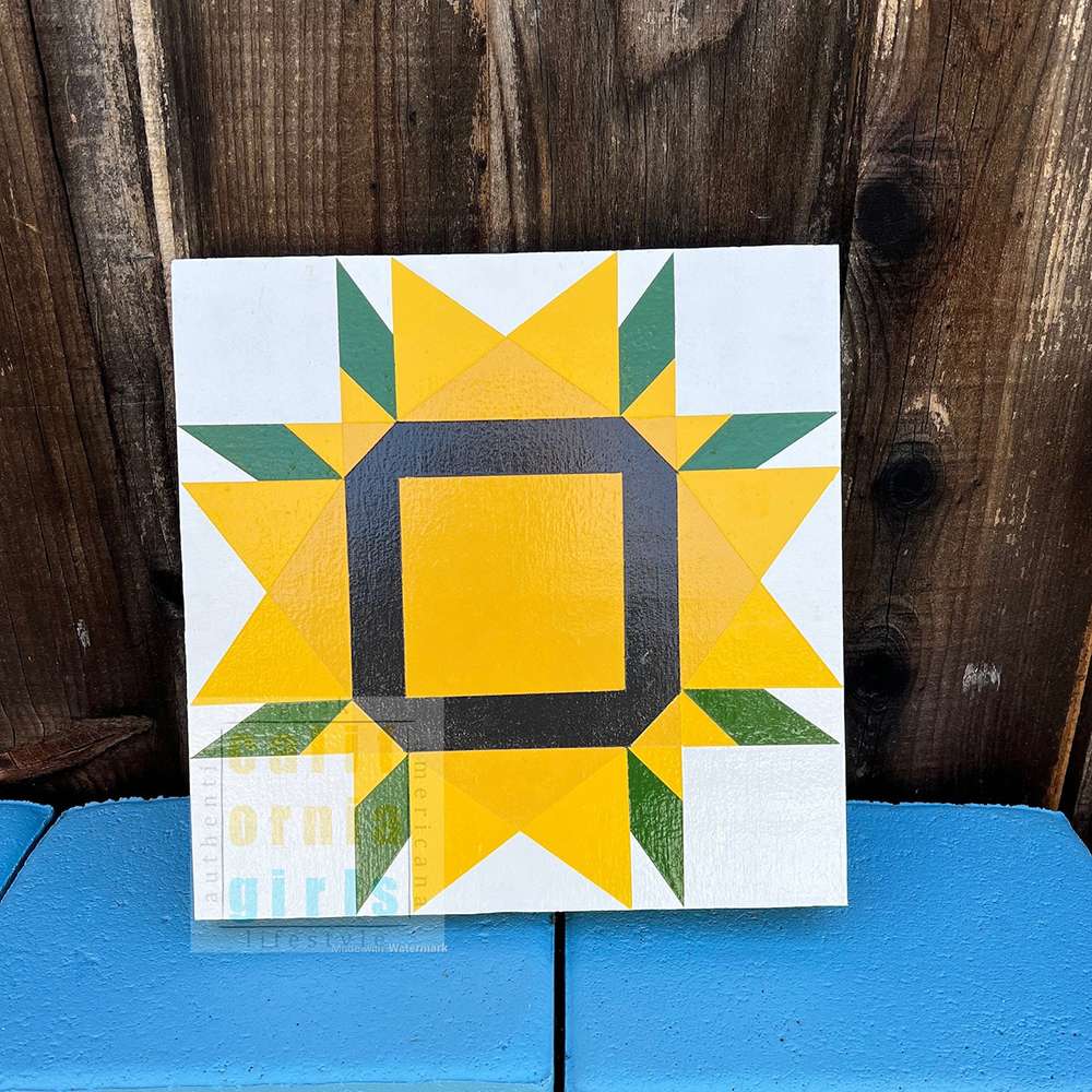 a sunflower barn quilt placed on the blue chair, leaning against the wooden wall