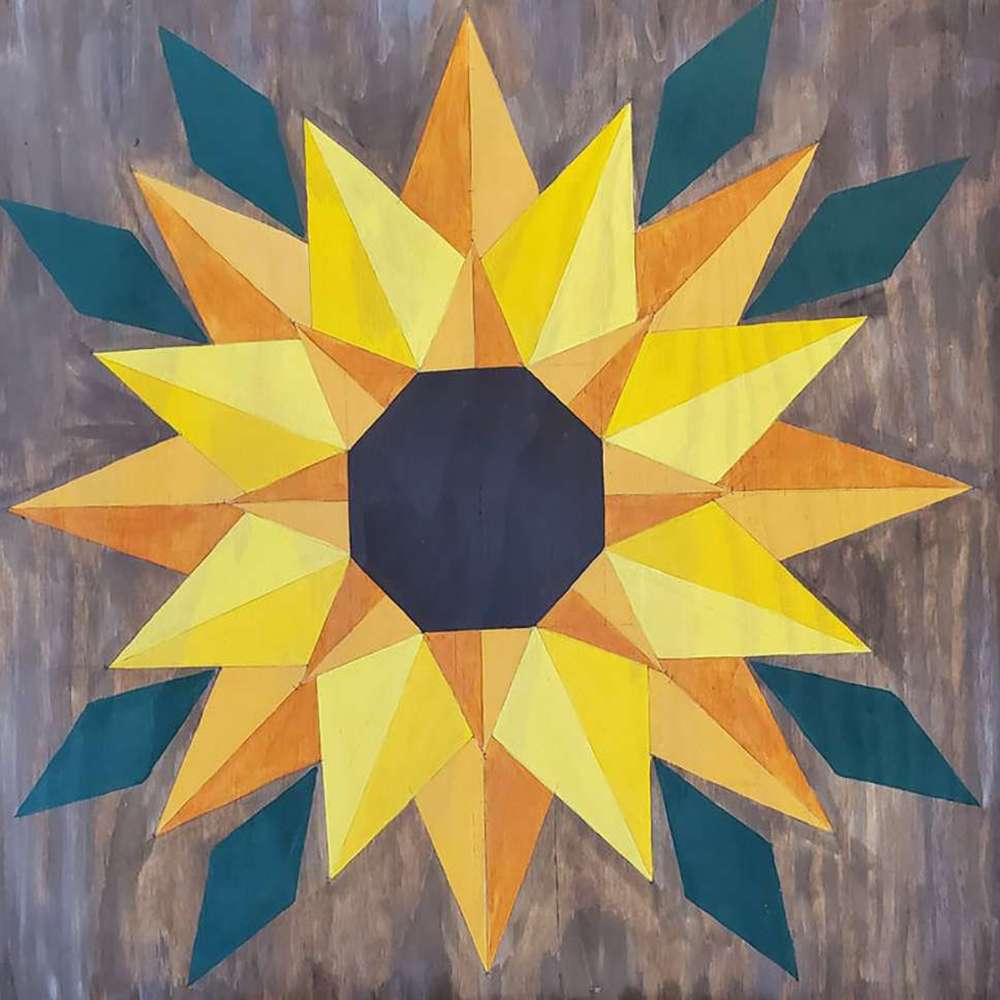 a barn quilt with sunflower pattern