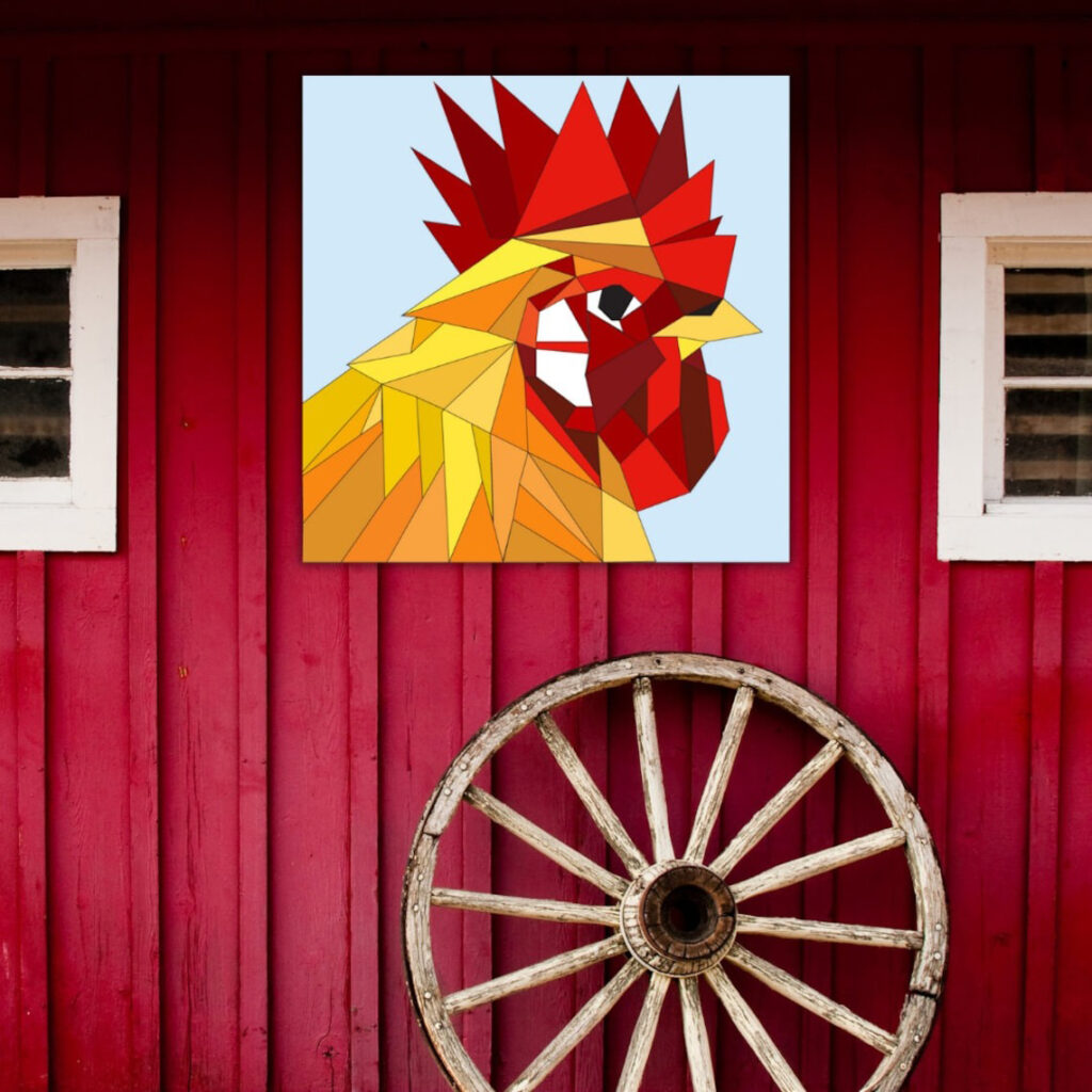 the barn quilt with rooster pattern hanging on the red wood wall