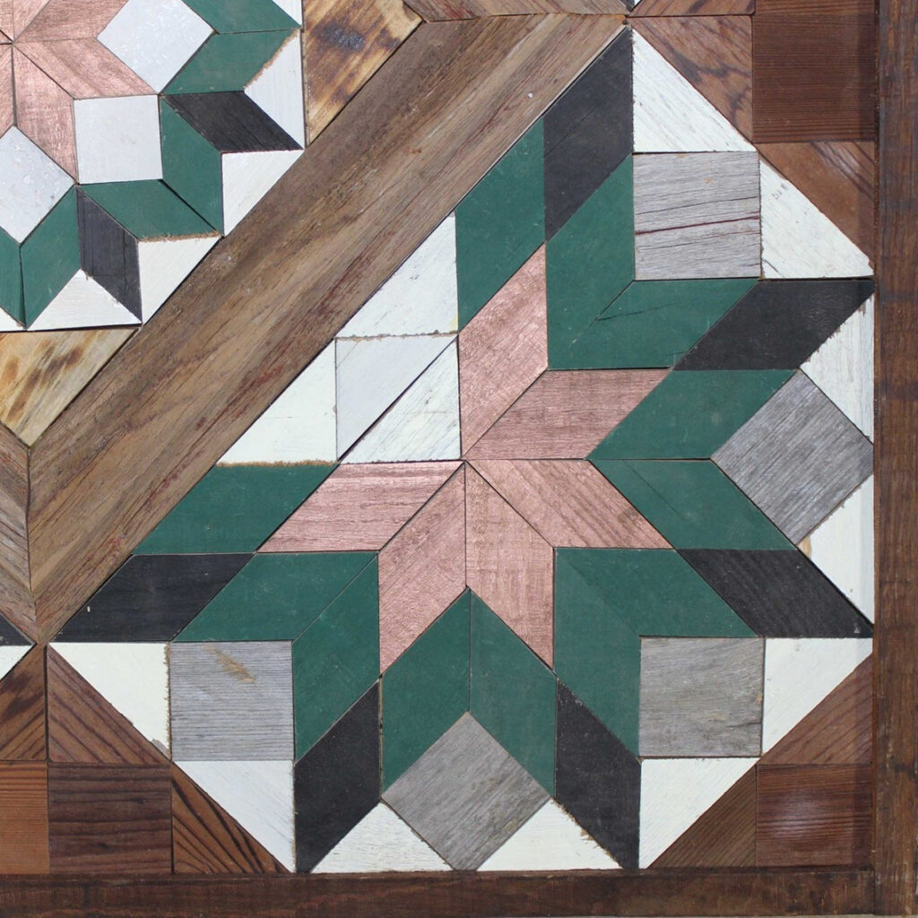 A part of the square barn quilt with five blue flower patterns.