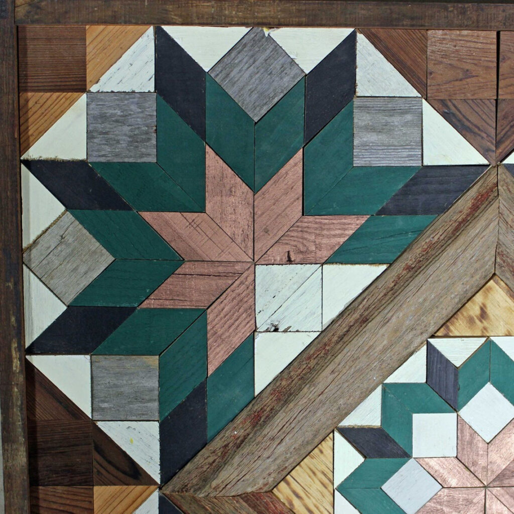 A part of the square barn quilt with five blue flower patterns.