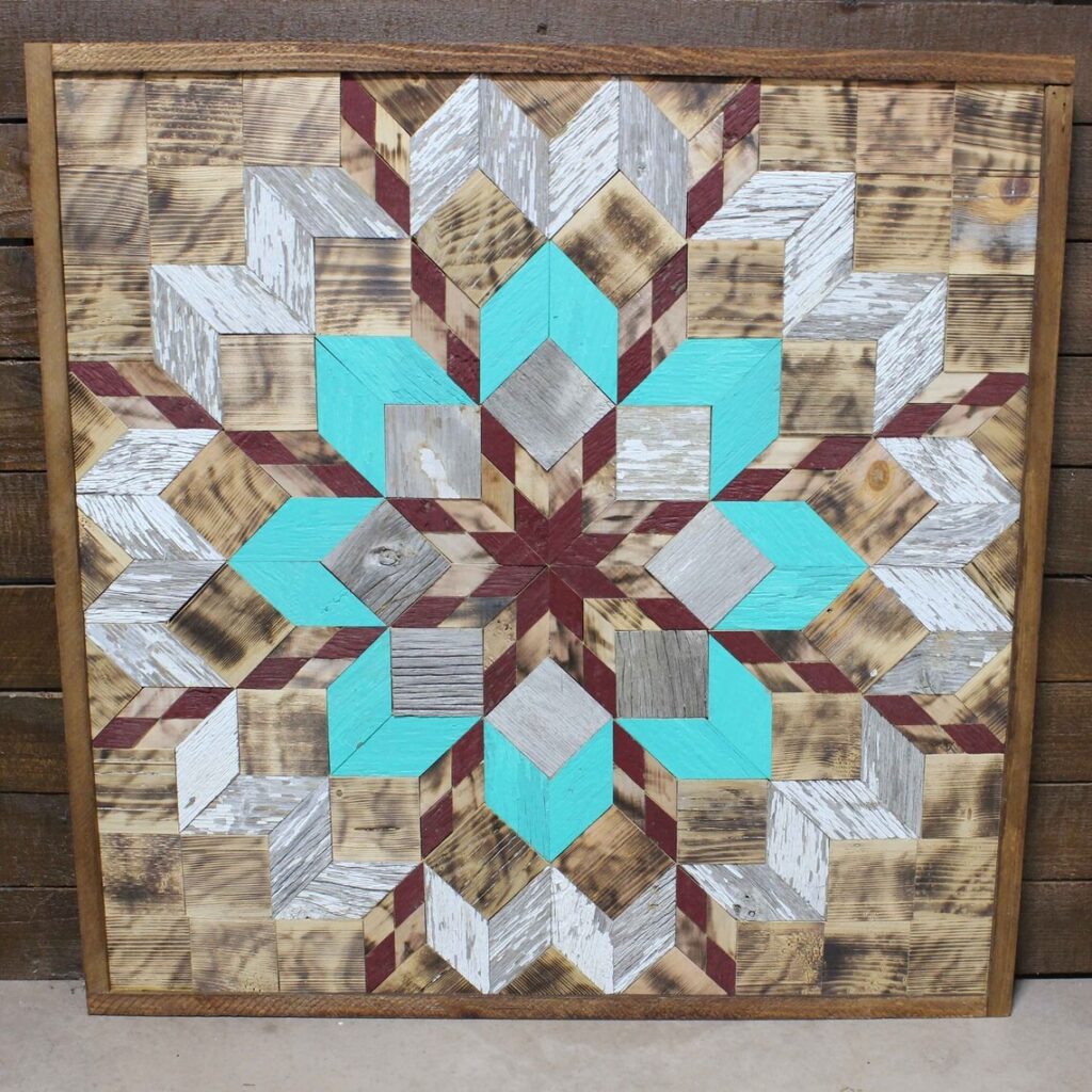 the square barn quilt with pearl flower pattern leaning against the wooden wall.
