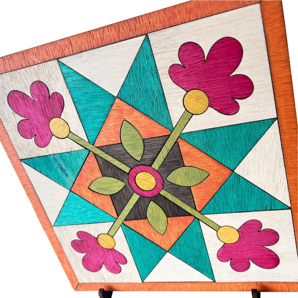 A part of a square barn quilt with stars and flower patterns was placed on the iron shelf.
