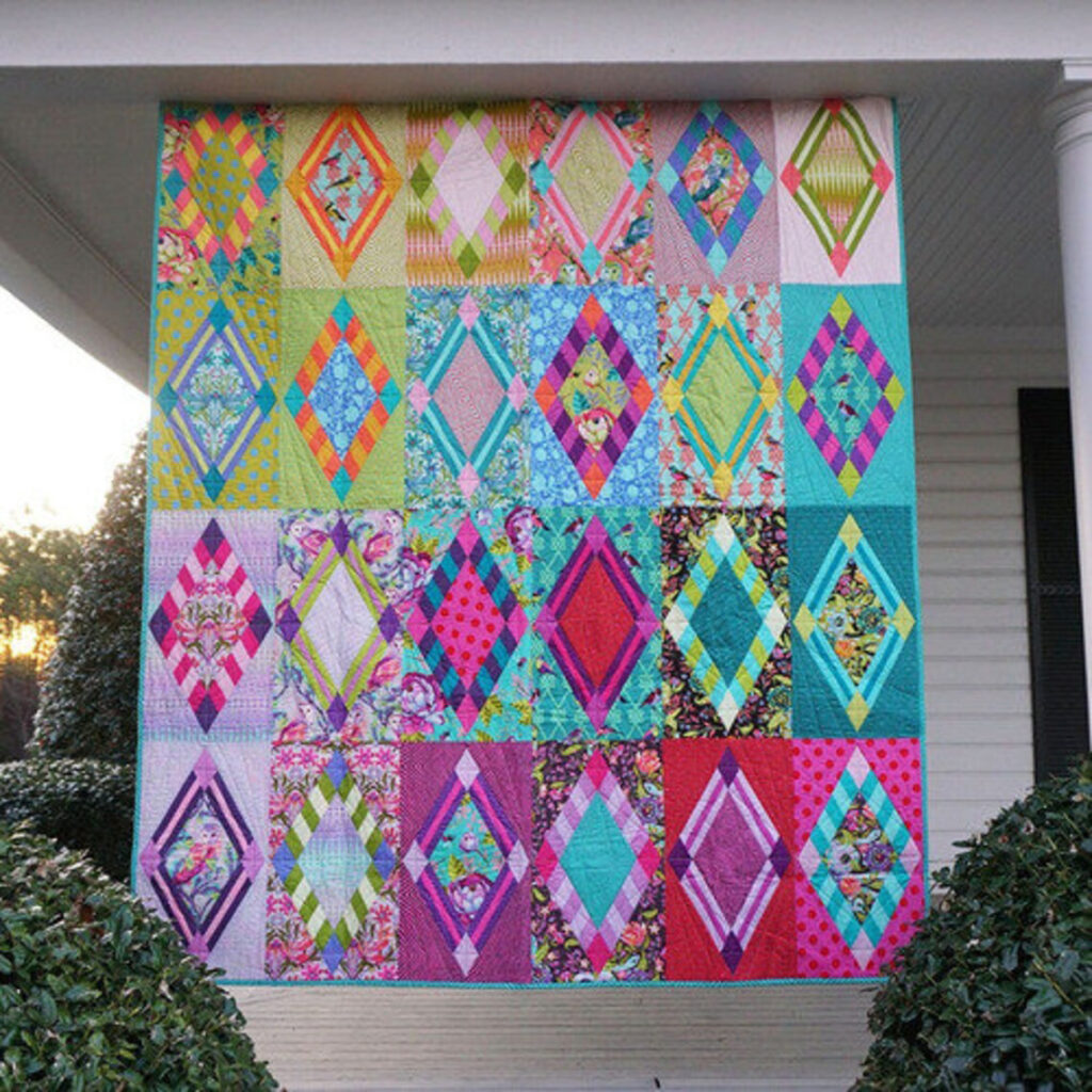 The Pink Rise and Shine Tula Quilt pattern is a vibrant and energetic design