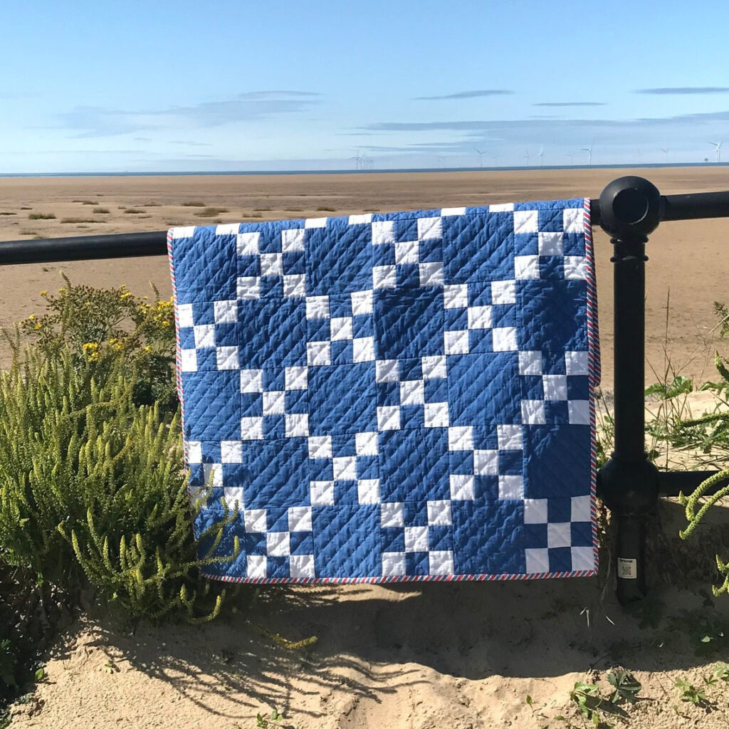 The quilt is designed in blue and white